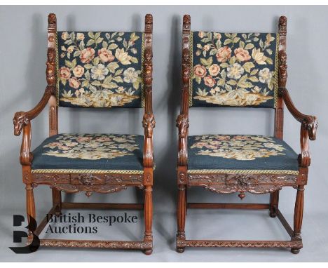 A pair of 19th Century library chairs in the Renaissance style, with rams head arm rests, tapestry upholstery and lions head 