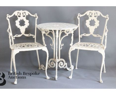 Painted cast alloy garden table and chairs. The table top and chairs having pierced decoration, with the table top raised on 