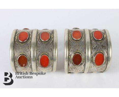 Pair of silver Turkamen carnelian cuff bangles, approx 60 mm in width, approx 300 gms. Condition report: partial signs of gil
