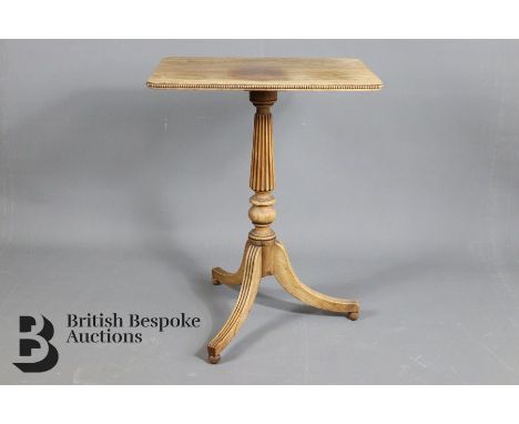 A late Regency rosewood tripod table. The table having a rounded rectangular top, supported on reeded turned column and termi