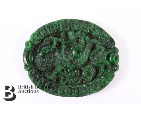Carved oval jade pendant of a dragon, pierced for suspension, approx 45 x 55 mm.&nbsp;