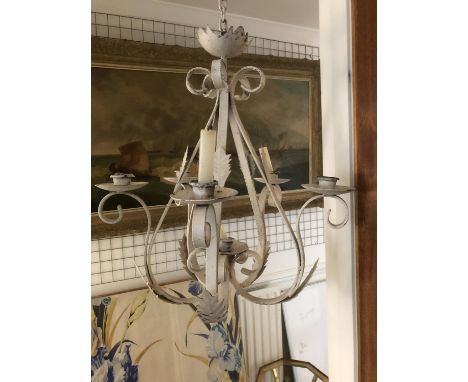 A French wrought iron six light chandelier fitted for candles, the arms applied with stiff leaves, chain and hook fittings, d