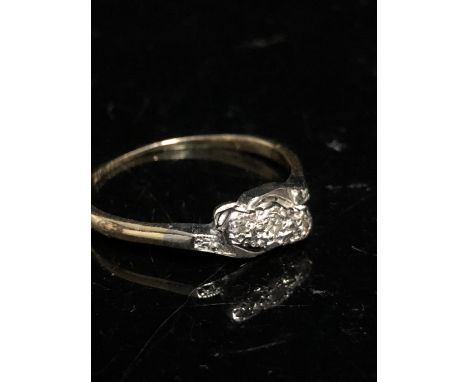 A three stone diamond ring, the stones of 8 cut, star illusion setting and shoulders in  platinum, yellow shank, stamped 18ct