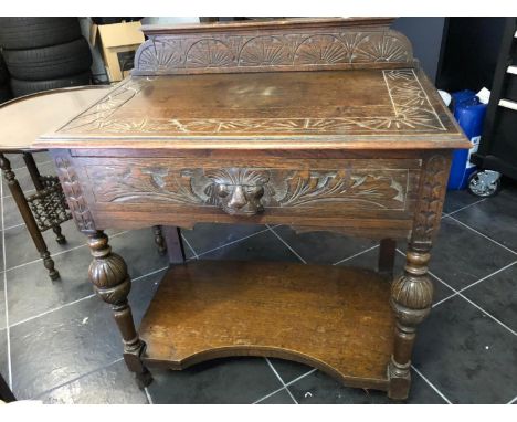 An ornate carved oak small side board, single drawer over baluster from legs and shaped shelf stretcher, 88cm high x 77cm wid