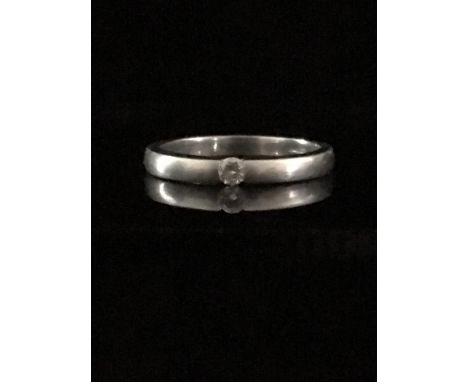 A 14ct white gold single stone diamond ring, tension style setting, stamped 14ct, ring size M, approx 2.68 mm diam, 0.07 ct, 