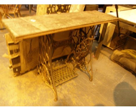 Singer treadle cast iron sewing machine base converted to table with wooden top and a garden bench 