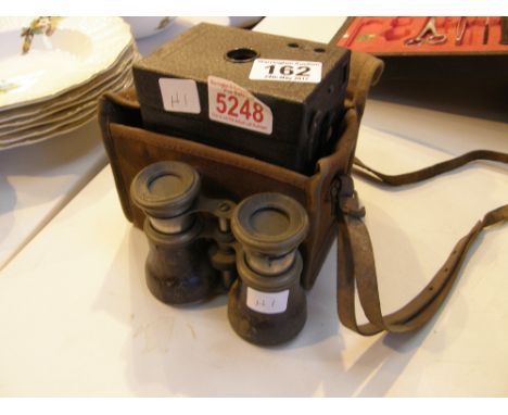 Vintage Kodak number two hawkeye box camera with case and a pair of nickel and leather binoculars marked Le Jockey Club Paris