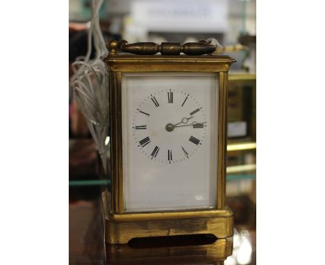An early 20th Century brass carriage clock, in need of a clean, some damage, complete with key, height approx. 18cm.