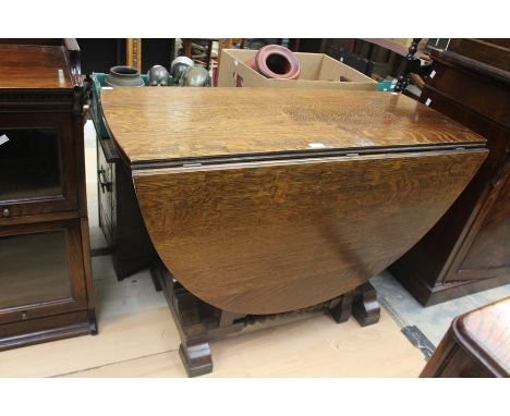 An early 20th century oak gate-leg table, raised on bobbin turned supports, with two leaves