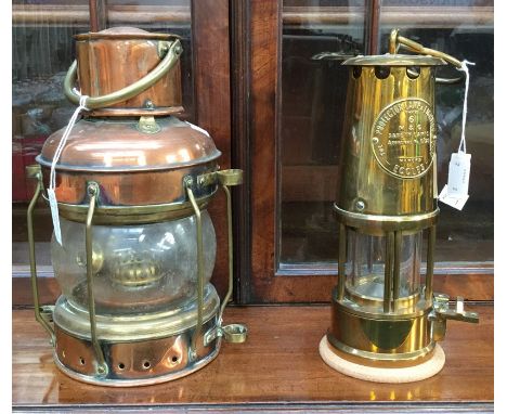 A miners protector lamp, Eccles, early 20th Century, together with a further copper and brass anchor ships light, early 20th 