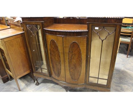 An Edwardian mahogany display cabinet, circa 1910, a pair of square glazed cabinets with two panel cupboards in between, rais