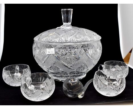 Cut glass crystal punch bowl with punch glass and ladle with lidCondition: One cup has a chip, the other three cups and ladle