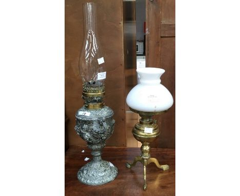 A pewter decorative oil lamp and also a brass early 20th Century oil lamp