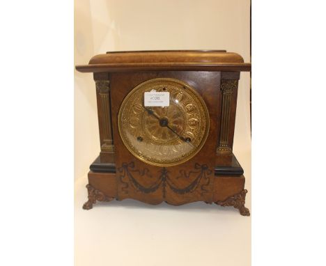 A walnut cased eight day mantle clock.