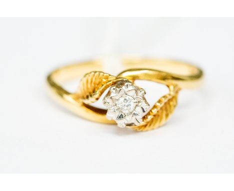 An 18ct gold and diamond solitaire ring, the illusion-set stone flanked by two leaves to shoulders, size N1/2, total gross we