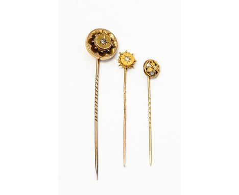 A collection of three stick pins, to include a Victorian diamond set version with 15ct gold terminal and unmarked yellow pin,