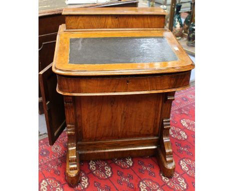 A mid Victorian walnut Davenport, a stationary box above an inlay writing slope, opens to pigeon holes, above four drawers an