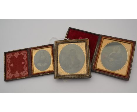 Three miniature Victorian Ambrotype&nbsp;photographic portraits. Two are in leather folder frames and have colour added and d