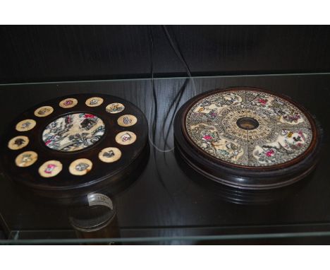 A Chinese ebony lidded compass, the lid inset with roundels depicting the Chinese years, the centre with a scene in a garden,