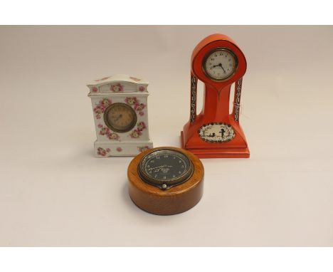 An Art Nouveau style clock in orange glaze, approx 225mm in height, no makers marks. Runs and ticks. Along with a Smiths Car 
