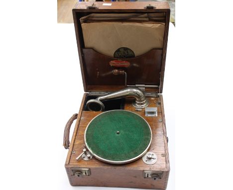 A Juno phone, circa 1920's, oak cased, wind up record player with a small collection of various 78's records.