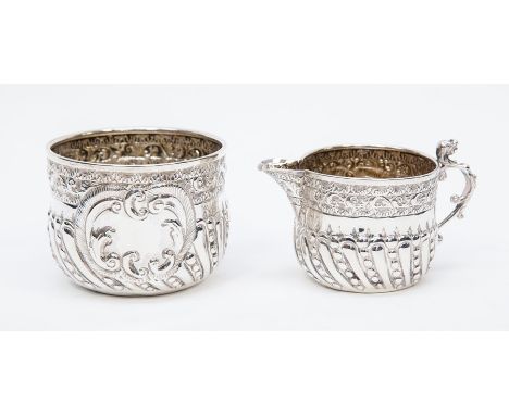 A silver sugar bowl and cream jug, embossed decoration, London 1892, maker&nbsp;William Hutton &amp; Sons (Edward Hutton), co