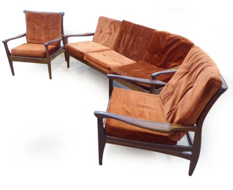 A 1960's teak three-seater sofa with loose red button upholstered together with a pair of matching high and lowback armchairs