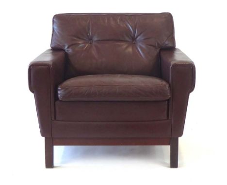 A 1970's Danish brown leather and button upholstered armchair, on square straight legs
