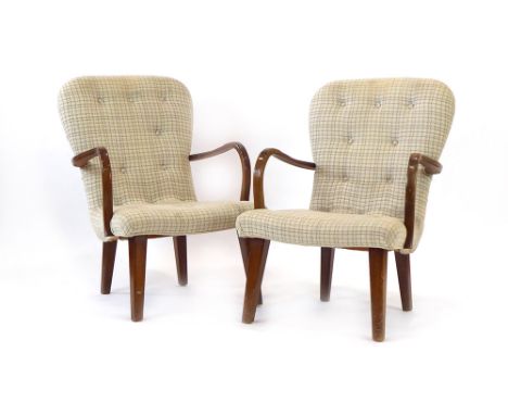 A pair of 1950/60's button upholstered armchairs with shaped beech arms and square tapering feet, in the manner of Philip Arc
