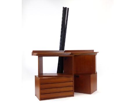 A 1960/70's teak modular shelving system including a chest, an open box-shelf, two cabinets, six shelves and eight metal upri