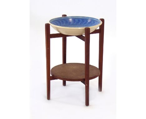 A 1970's plant stand, the ceramic dish resting on a teak stand, h. 45 cm, together with a folding teak table