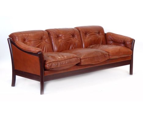 A 1970's Danish three-seater sofa in dark red with an exposed stained beech frame of circular form CONDITION REPORT: Structur