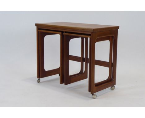 A McIntosh teak buffet table, l. 76 cm, with two smaller tables nesting below, on castors