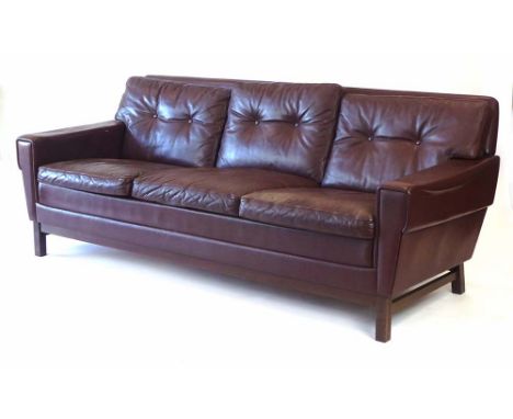 A 1970's Danish brown leather and button upholstered three-seater sofa, on square straight legs, l. 188 cm