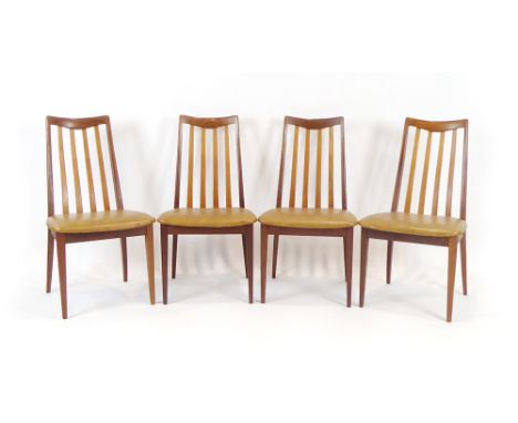 A set of four late 1960's G-Plan dining chairs with teak slatted backs over light brown seats, red labels