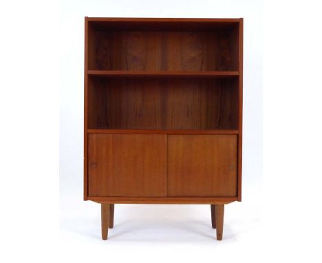 A 1970's Danish teak bookcase, the open front over two sliding doors on turned legs, by Sejling Skabe, w. 87 cm CONDITION REP