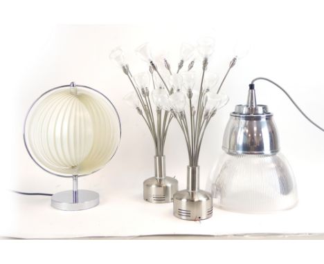 A group of contemporary lighting including a spiral lamp, the white plastic concentric shade within a chromed arc, three orga