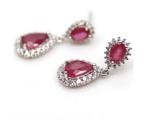 A pair of 925 silver drop earrings set with pear cut rubies surrounded by white stones, L. 2.4cm.