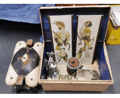A tin trunk with a camel saddle stool and other items.
