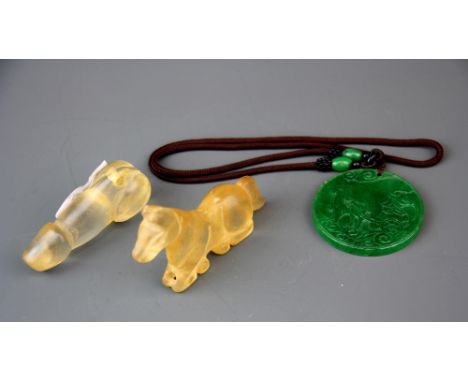 A Chinese carved rock crystal fertility amulet L. 7.5cm. Together with a rock crystal horse and a green jade/ hardstone amule