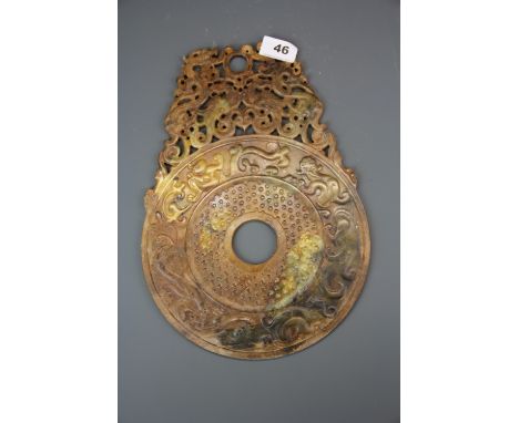 A Chinese carved archaic form jade pi disc, H. 32cm, W. 22.5cm.