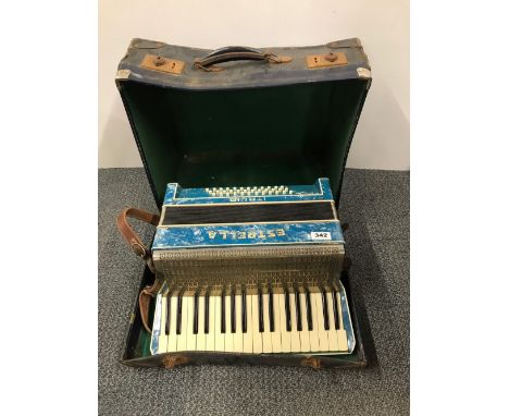 A cased Estrella piano accordion.