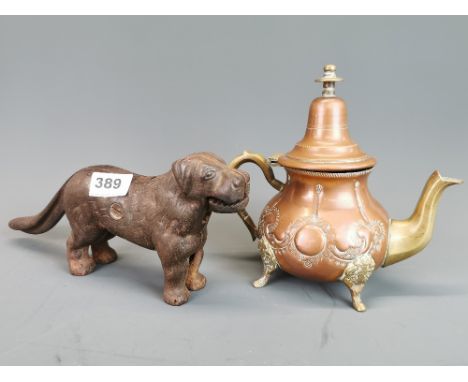 An antique cast iron dog nutcracker, together with a copper and brass coffee pot.