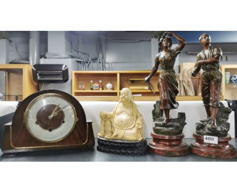 A pair of French cold painted spelter figures, together with a Buddha figure and a mantle clock.