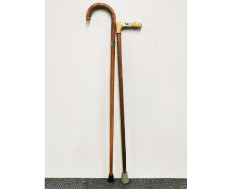 An antler handle walking stick, together with a silver mounted walking stick