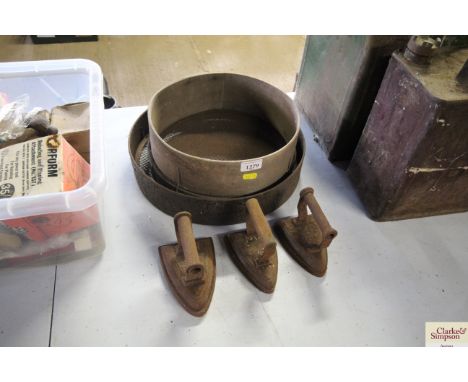 Two wooden garden sieves and three vintage irons