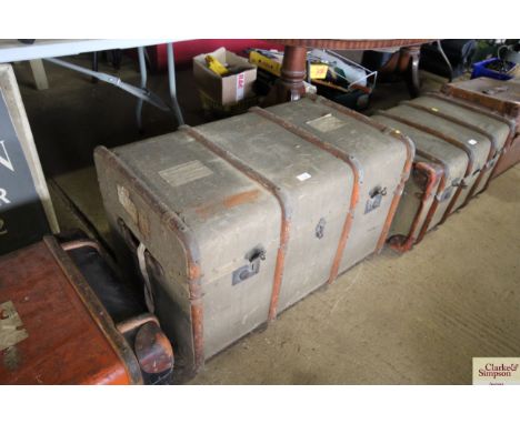 A wooden and metal bound travelling trunk with internal tray