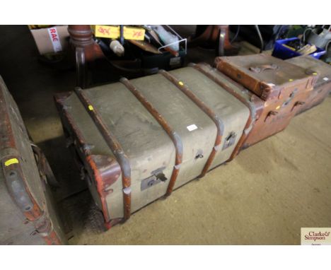 A wooden and metal bound travelling trunk with floral decoration and internal tray