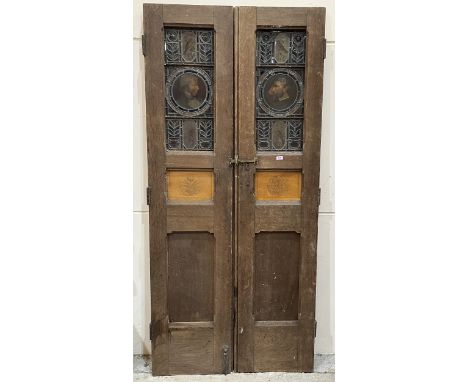 A pair of oak panelled doors, each with a stained glass pane depicting a portrait, bird and foliage. 86" x 19" (Each door)
