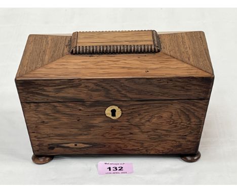 A Regency rosewood sarcophagus tea caddy on bun feet. 8" wide